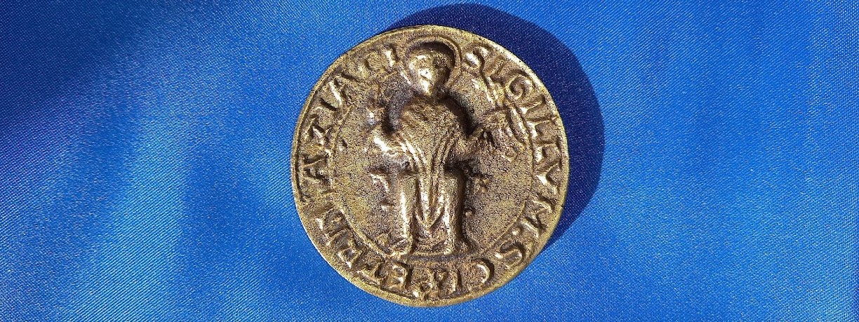 seal from the old abbey on a field of blue cloth